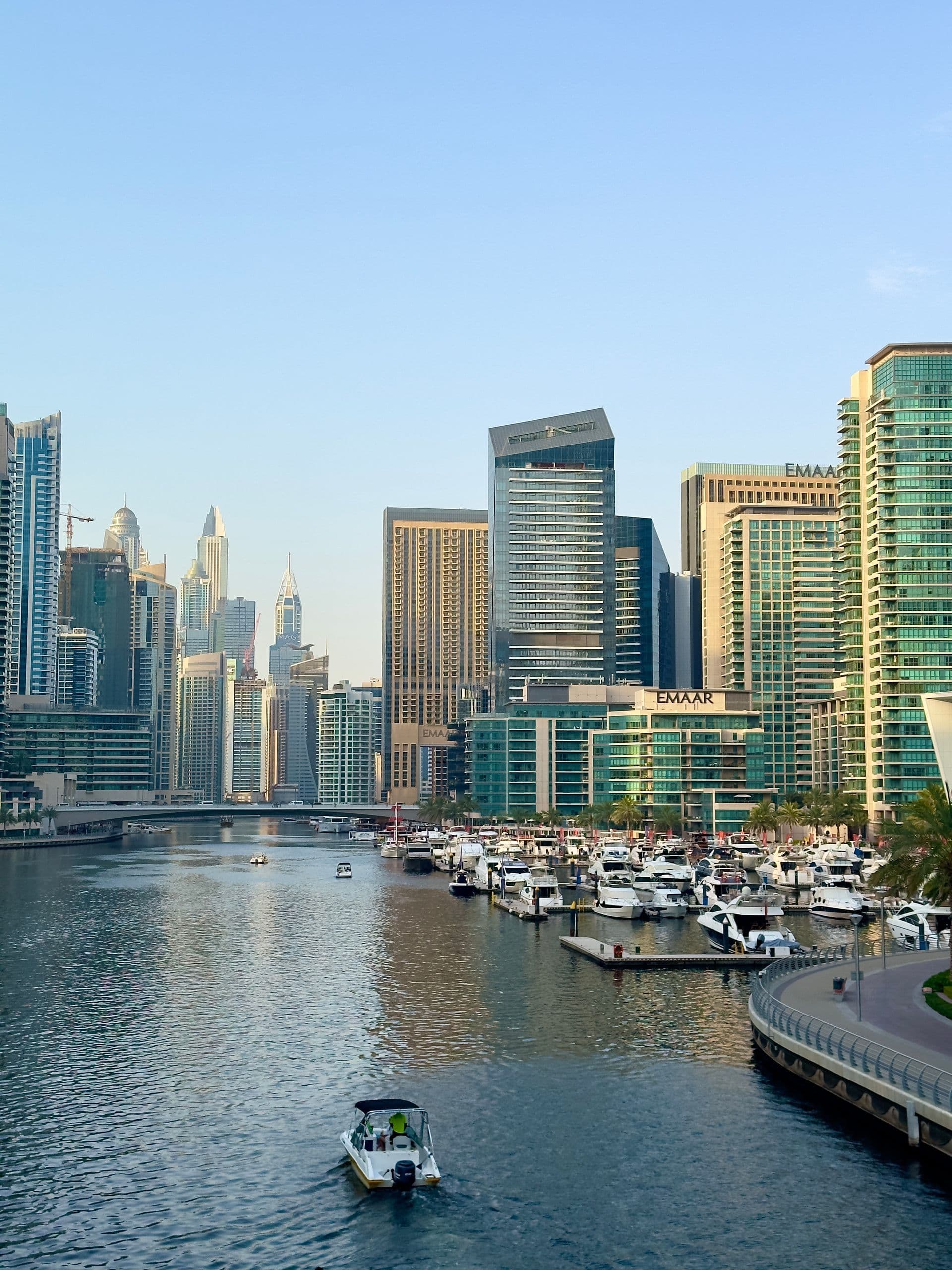 Dubai Marina at golden hour, looking along the water toward the towers